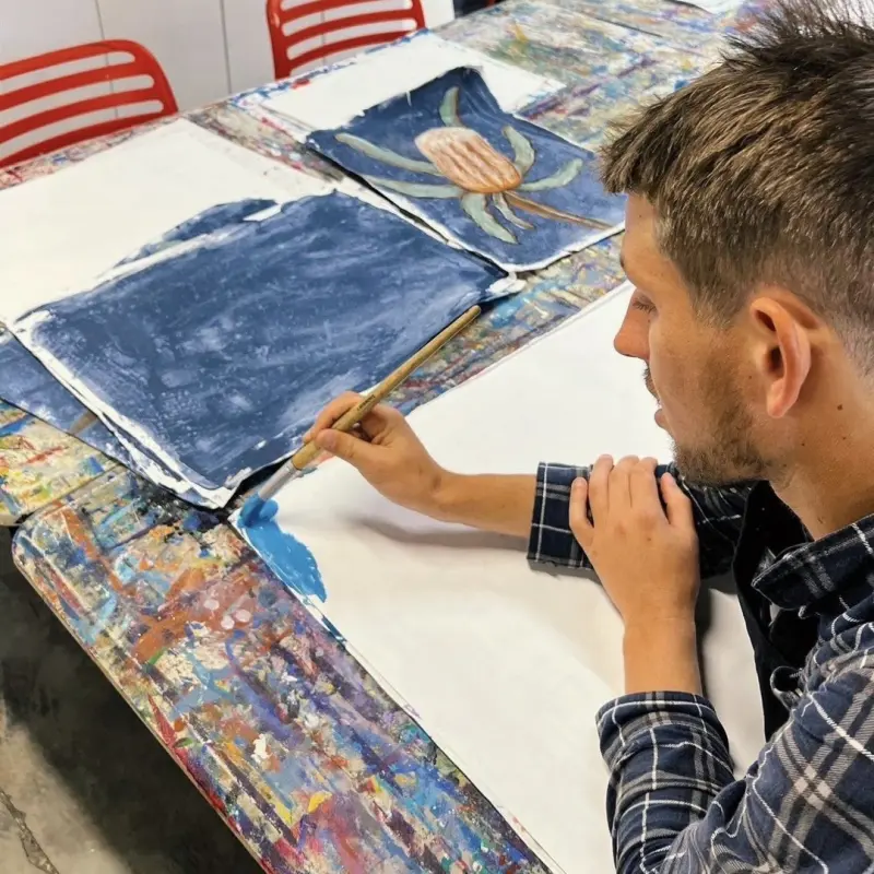 Invigorate Ability Support - 37 A participant painting at a table